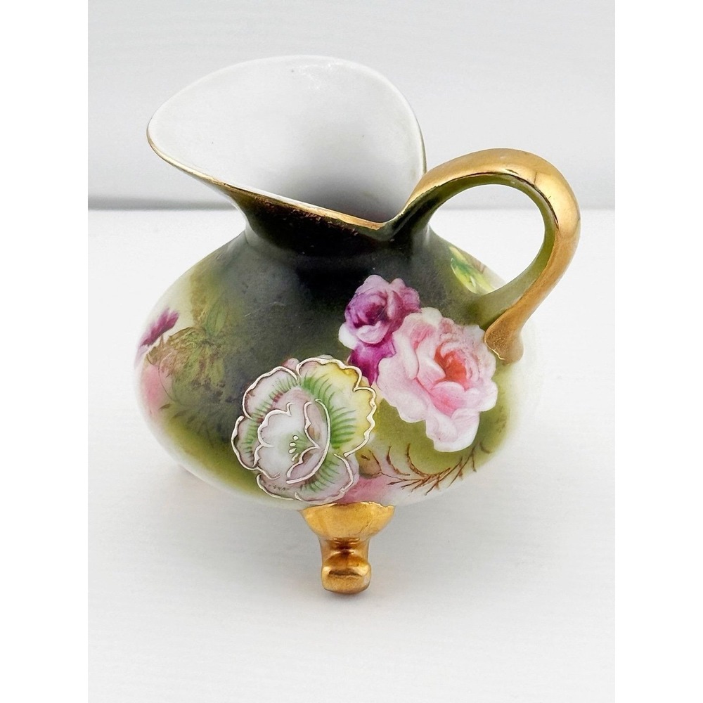 Vintage Karl-Heinz Klette porcelain German pitcher with gilt footed legs.
